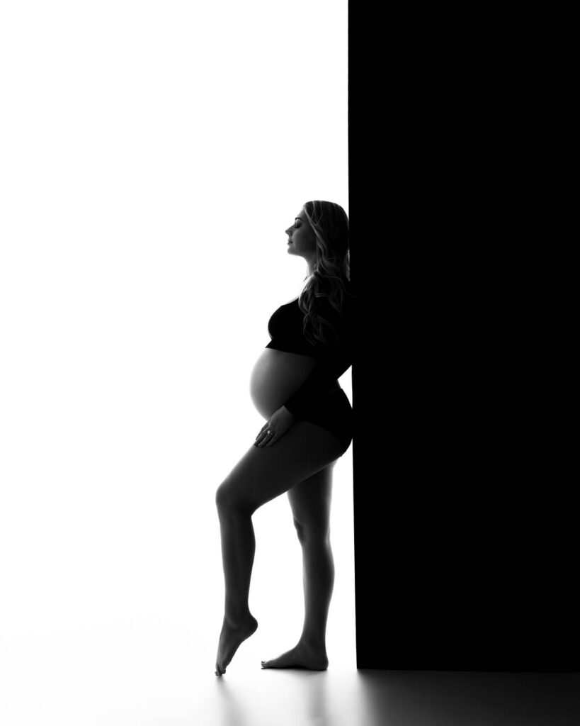 Fine Art Maternity Silhouette Portrait In A Dallas Photography Studio With Dramatic Black And White Lighting