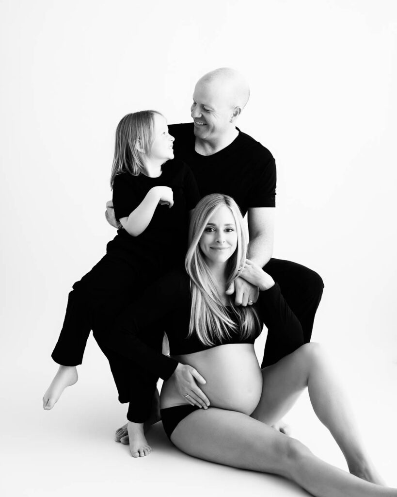 Important Questions To Ask Your Maternity Photographer 7 Black And White Family Maternity Portrait Captured In A Dallas Photography Studio