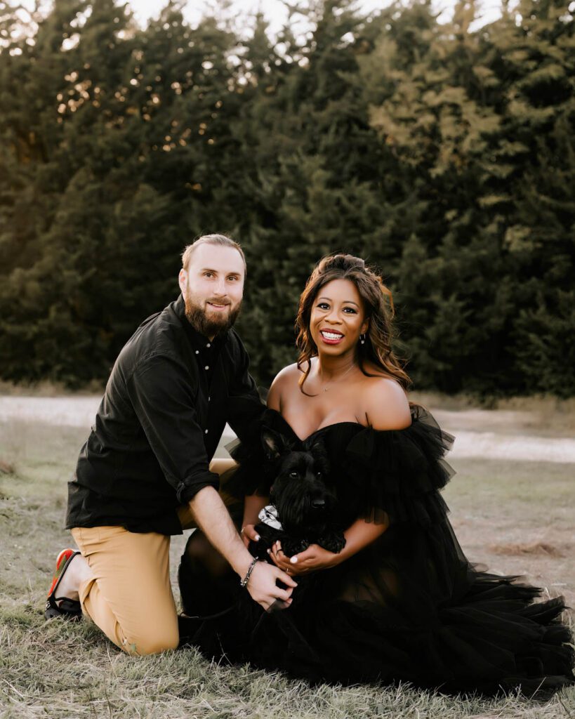 Maternity Photos With Pets: When Your First Baby Joins The Session 9 Dallas Maternity Session With Your Dog Showing An Expecting Couple Sitting Together With Their Beloved Pet During An Outdoor Photoshoot.