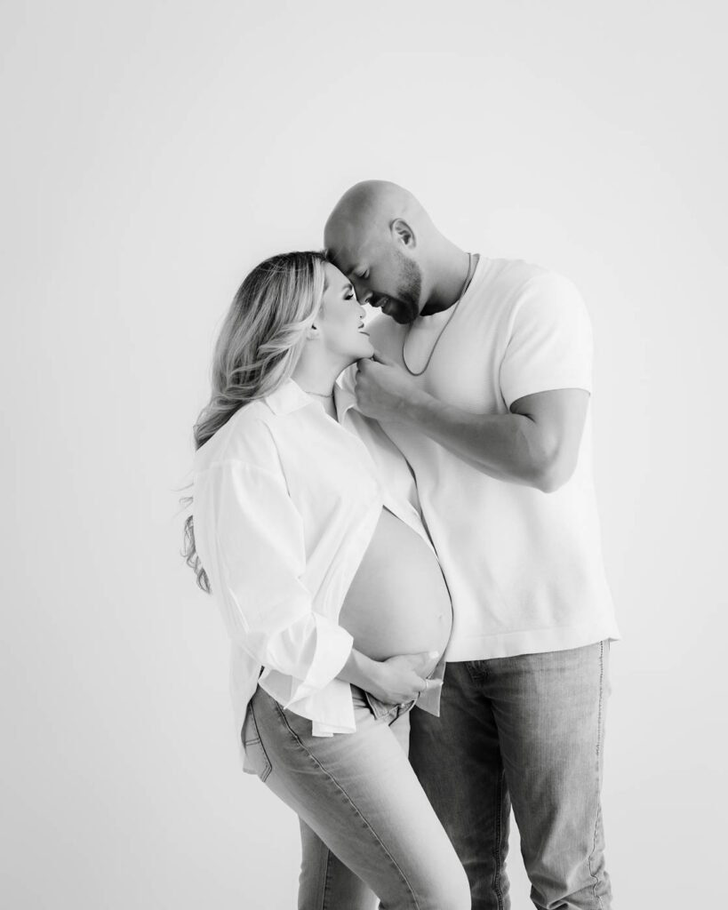 Expecting Parents Sharing A Quiet Moment During A Maternity Photography Session.