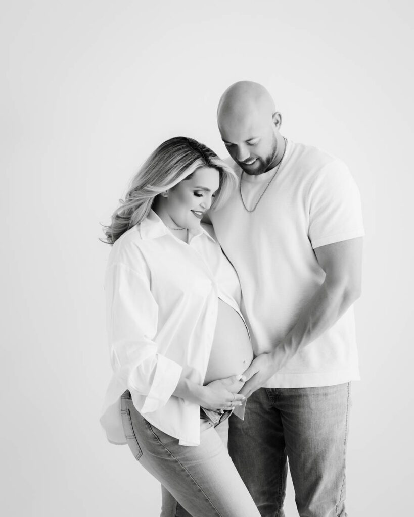 Expecting Parents Posing Together During A Maternity Photography Session In Dallas, Texas.