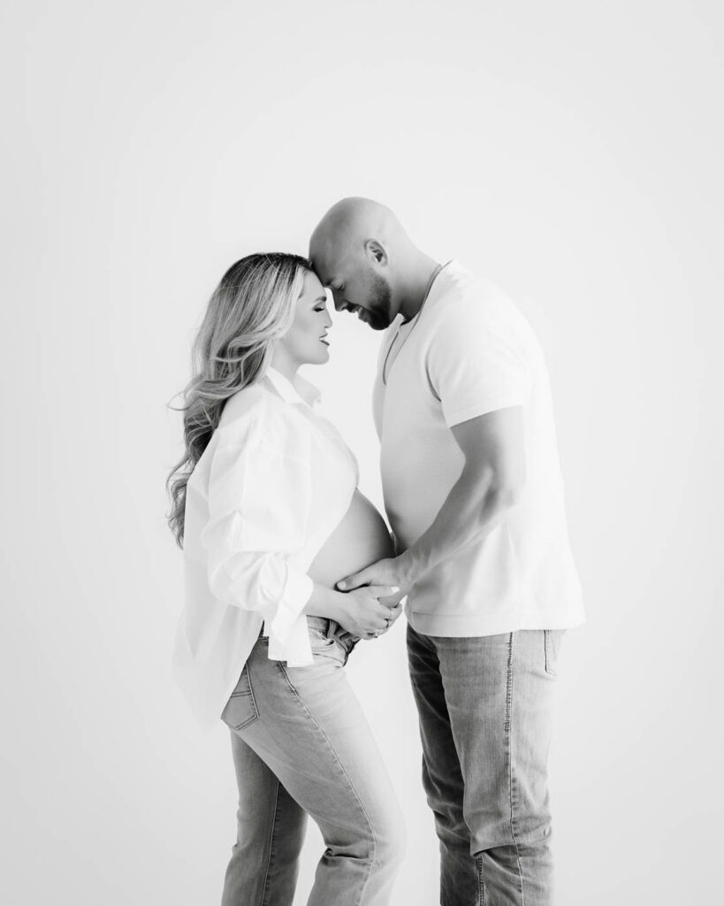 Expecting Couple Embracing During A Dallas Maternity Photography Session.