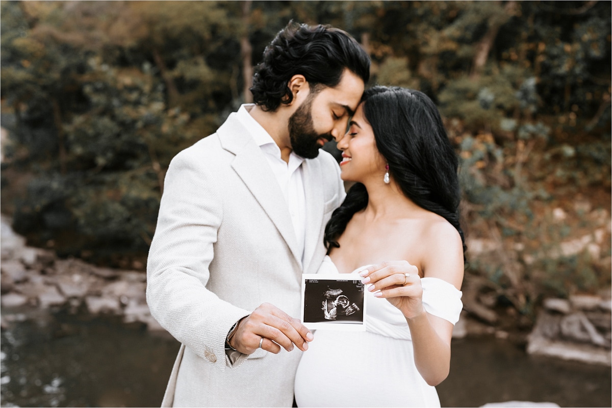 Maternity Couple Embraces While Holding An Ultrasound For Dfw Maternity Photographer