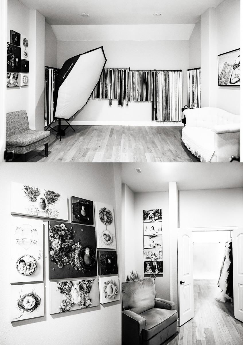 Black And White Photo Of A Studio With Various Artworks On The Walls, A Large Photography Softbox, Chairs, And Fabric Rolls.