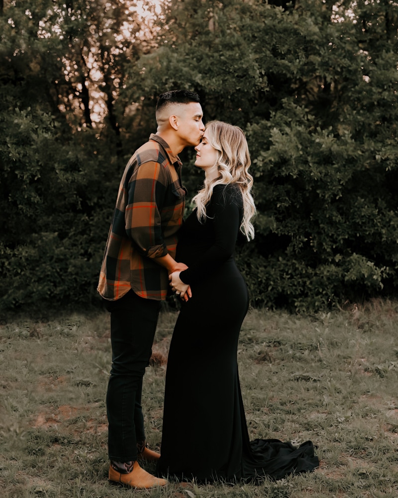 Standing Couple Embraces Outdoor During Golden Hour For A Maternity Photoshoot Dallas