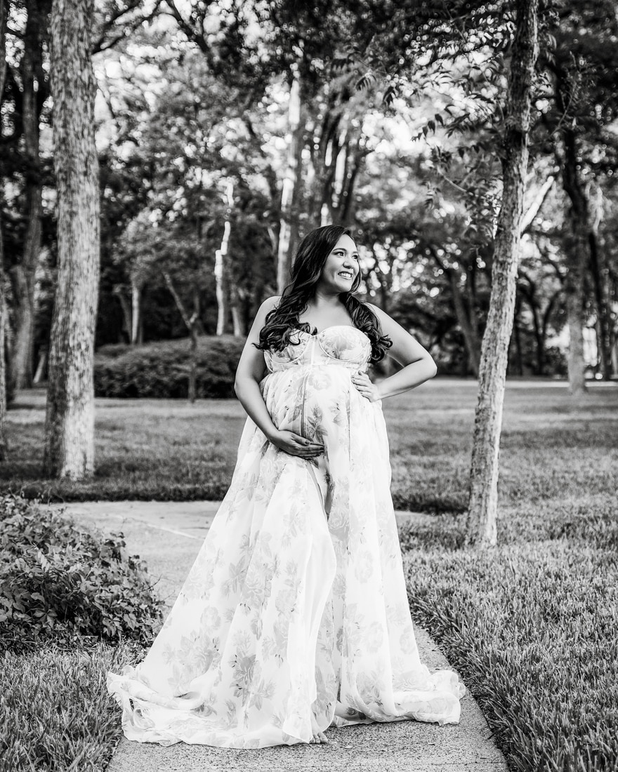 Pregnant Woman On A Pathway In A Wooded Park, Smiling For A Maternity Photos Dallas