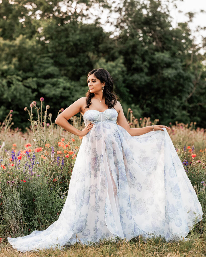 Outdoor Maternity Portrait Featuring Flowing Floral Dress In Natural Field Setting