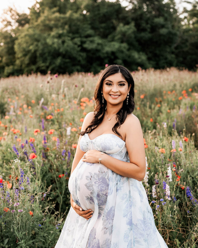 Pregnant Mother Posing In A Wildflower Field During Outdoor Maternity Photography Session