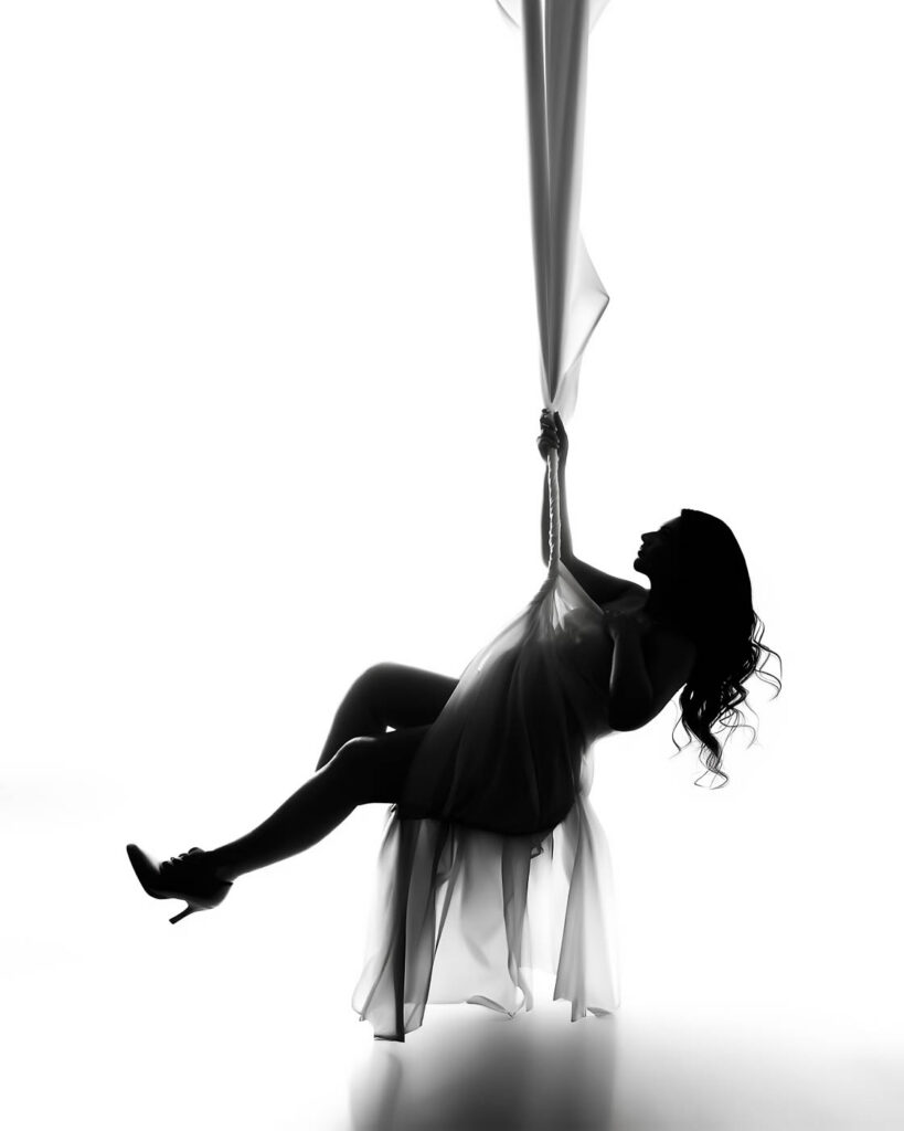 Editorial Maternity Photography Silhouette Featuring Dramatic Fabric Movement In Dallas Studio