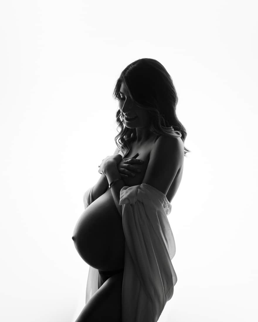 Black And White Silhouette Of A Pregnant Woman Holding Belly For Maternity Photography Dallas