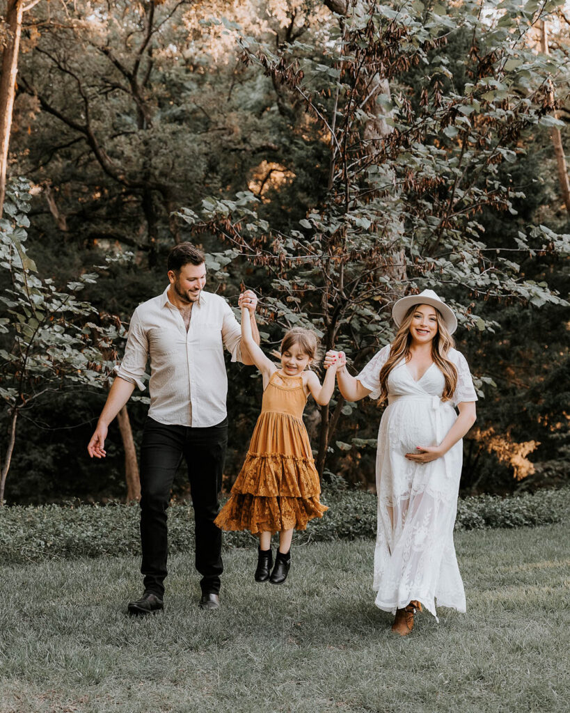 Why Sharing Your Pregnancy Journey Matters 8 Outdoor Family Maternity Session In Dallas With Parents And Daughter Walking Together.