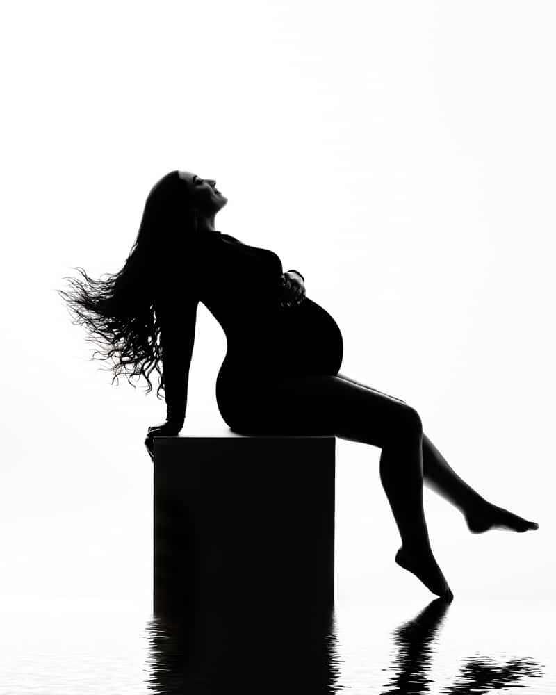 Maternity Silhouette Photography Of A Pregnant Woman Sitting On A Box For Pregnancy Photographer Dallas