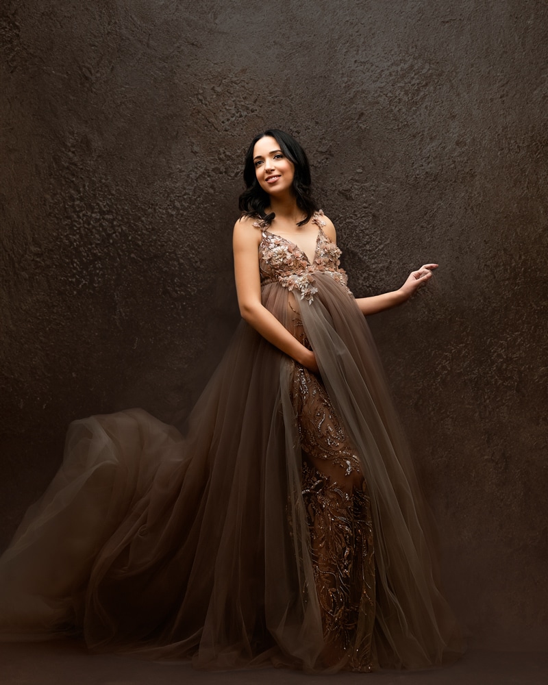 Maternity Photographer | Crucial Questions You Should Ask 1 Pregnant Woman Against A Textured Backdrop Smiling For Dfw Maternity Photographer