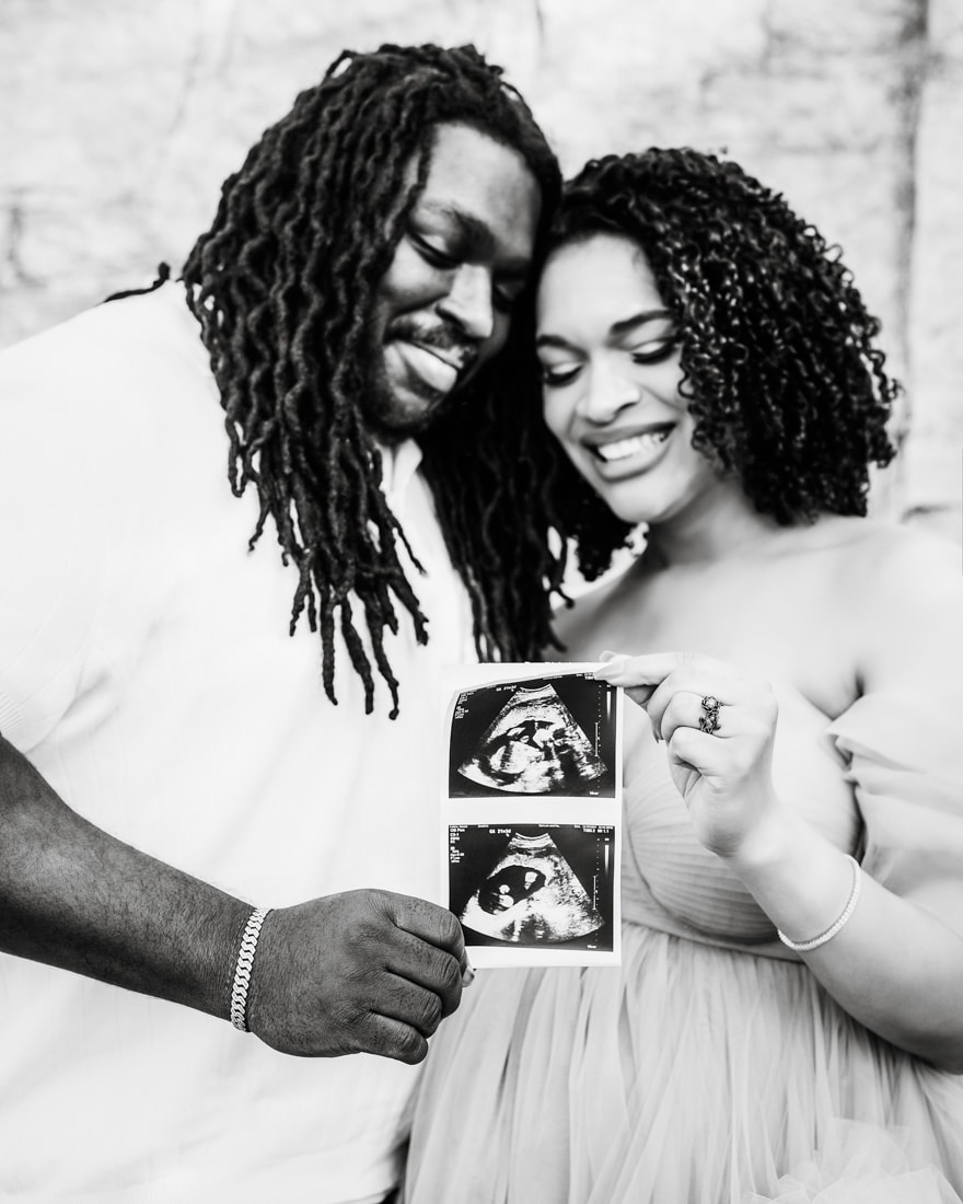 Couple In A Joyful Embrace Holds An Ultrasound For Dallas Maternity Photography