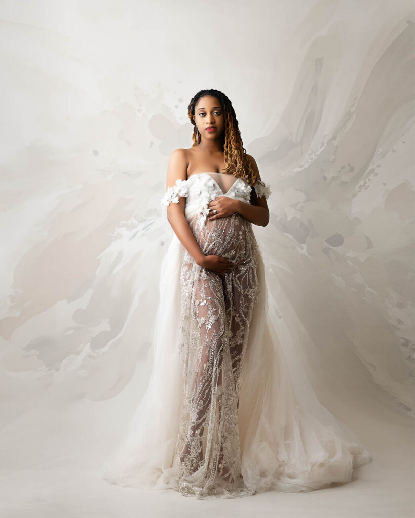 Elegant Studio Maternity Portrait Featuring Neutral Couture Gown And Soft Editorial Styling