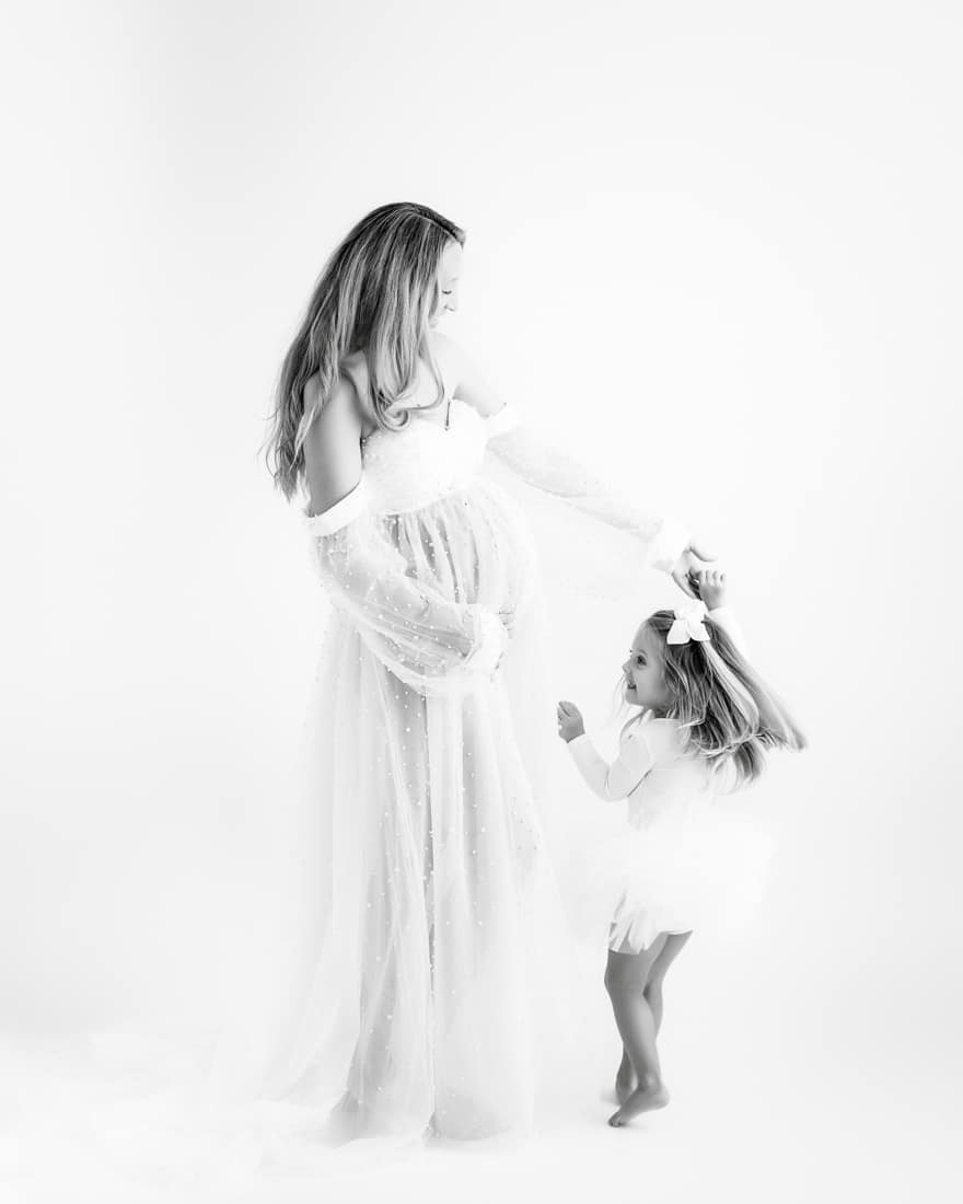 Woman In A Sheer Dress Holds Hands With A Young Girl In A Tutu For Dfw Maternity Photographer