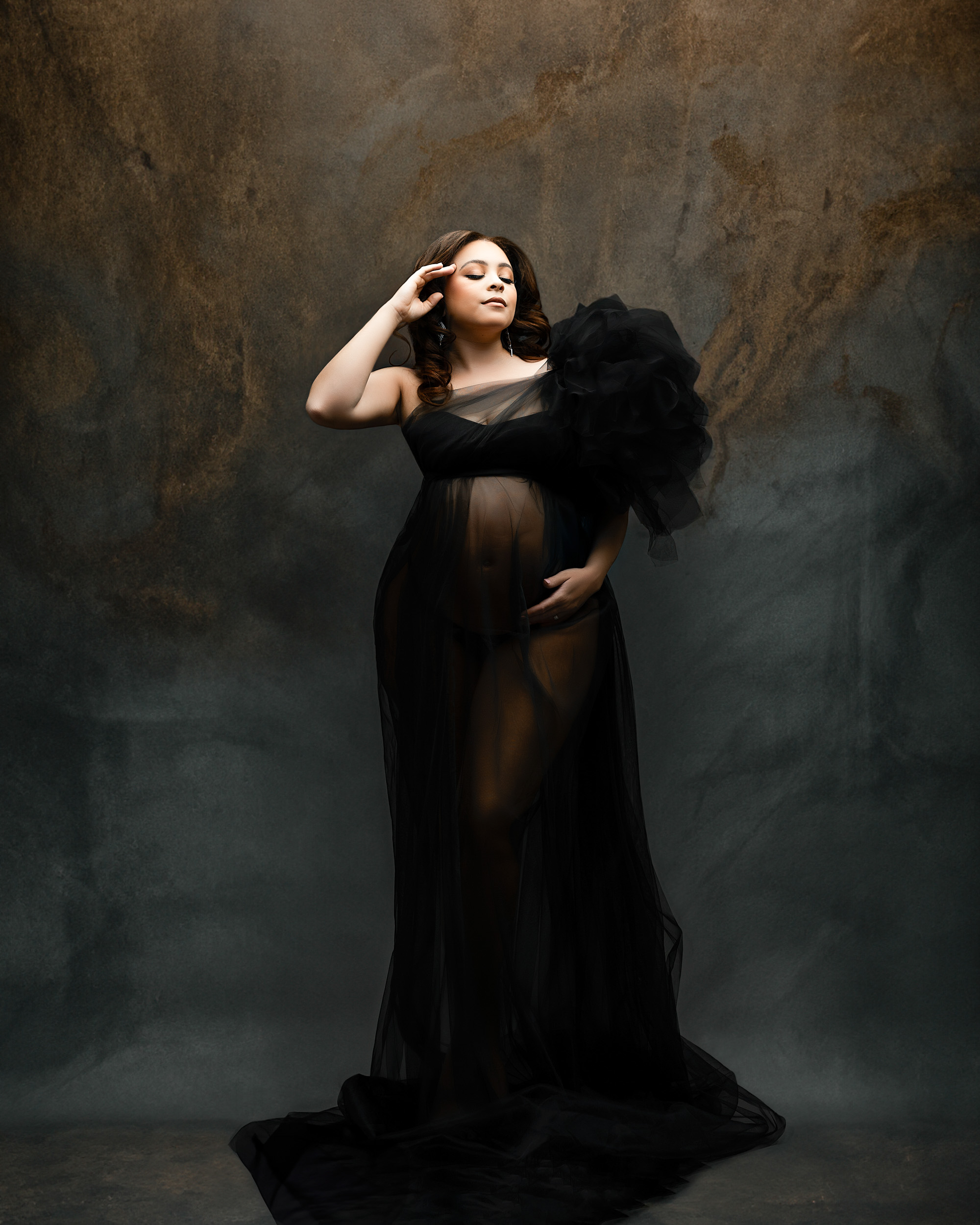 pregnant woman in sheer black gown posing during a maternity session in Dallas by Lily Hayes Photography