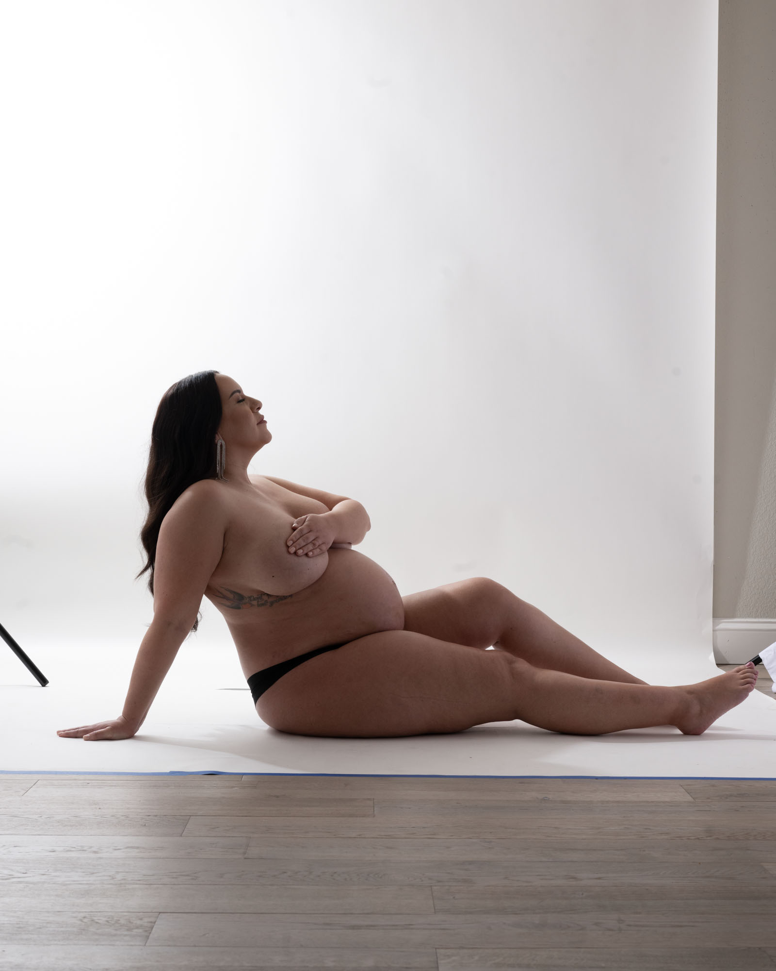 Pregnant woman posing in studio maternity boudoir portrait, Dallas maternity photographer