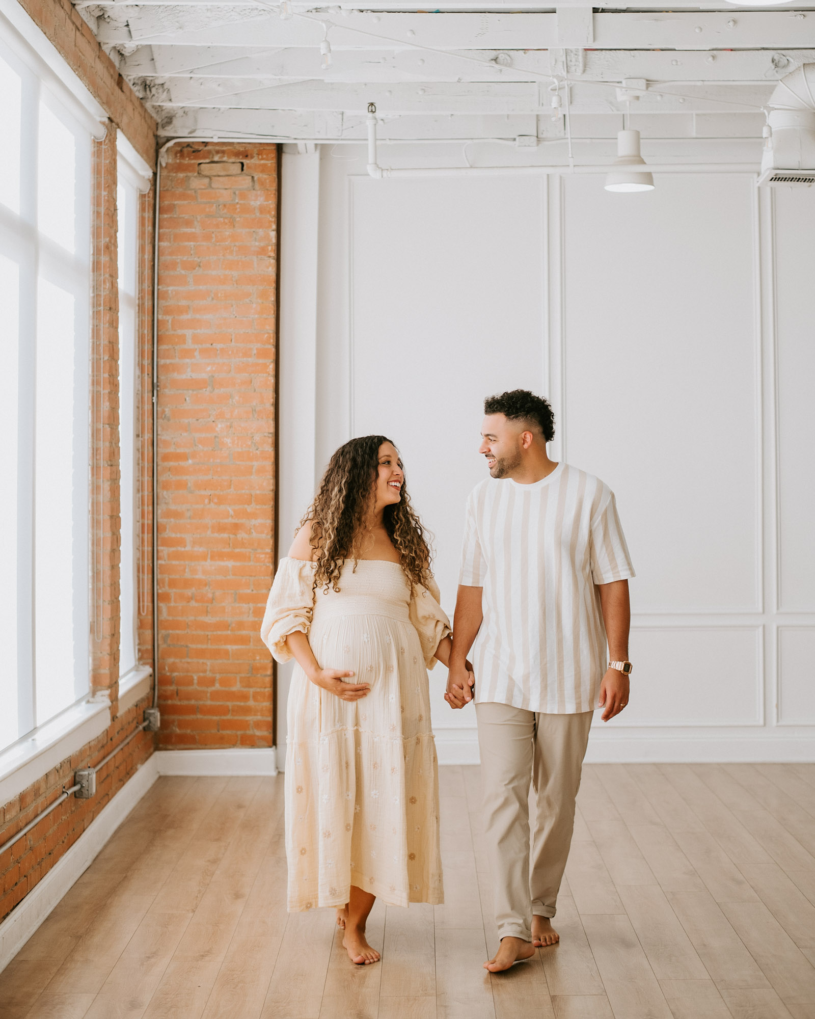 Expecting Couple Walking Hand In Hand During Dallas Maternity Photos
