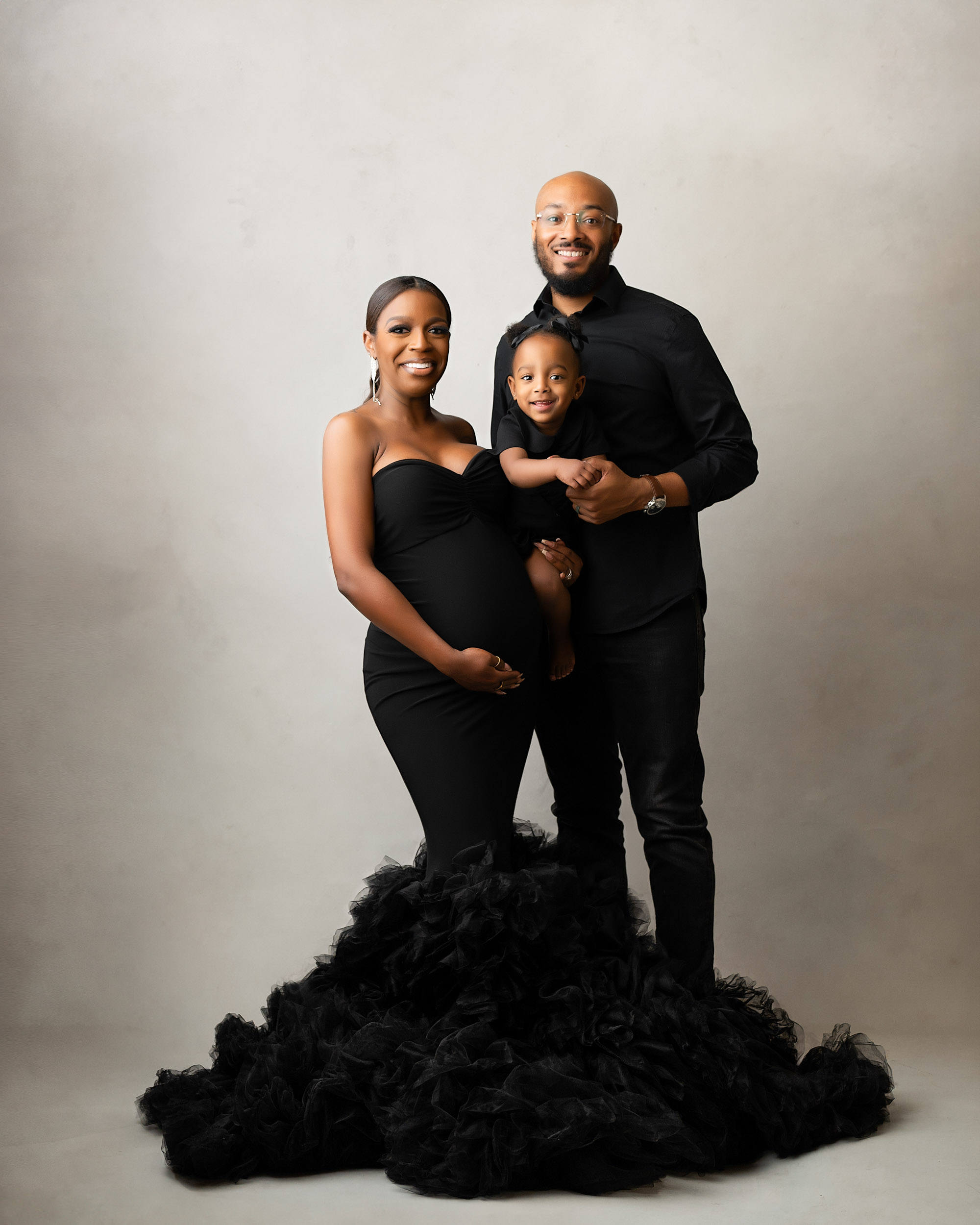 Smiling Family Portrait During A Maternity Photoshoot In Dallas With Expecting Mother In Elegant Black Gown