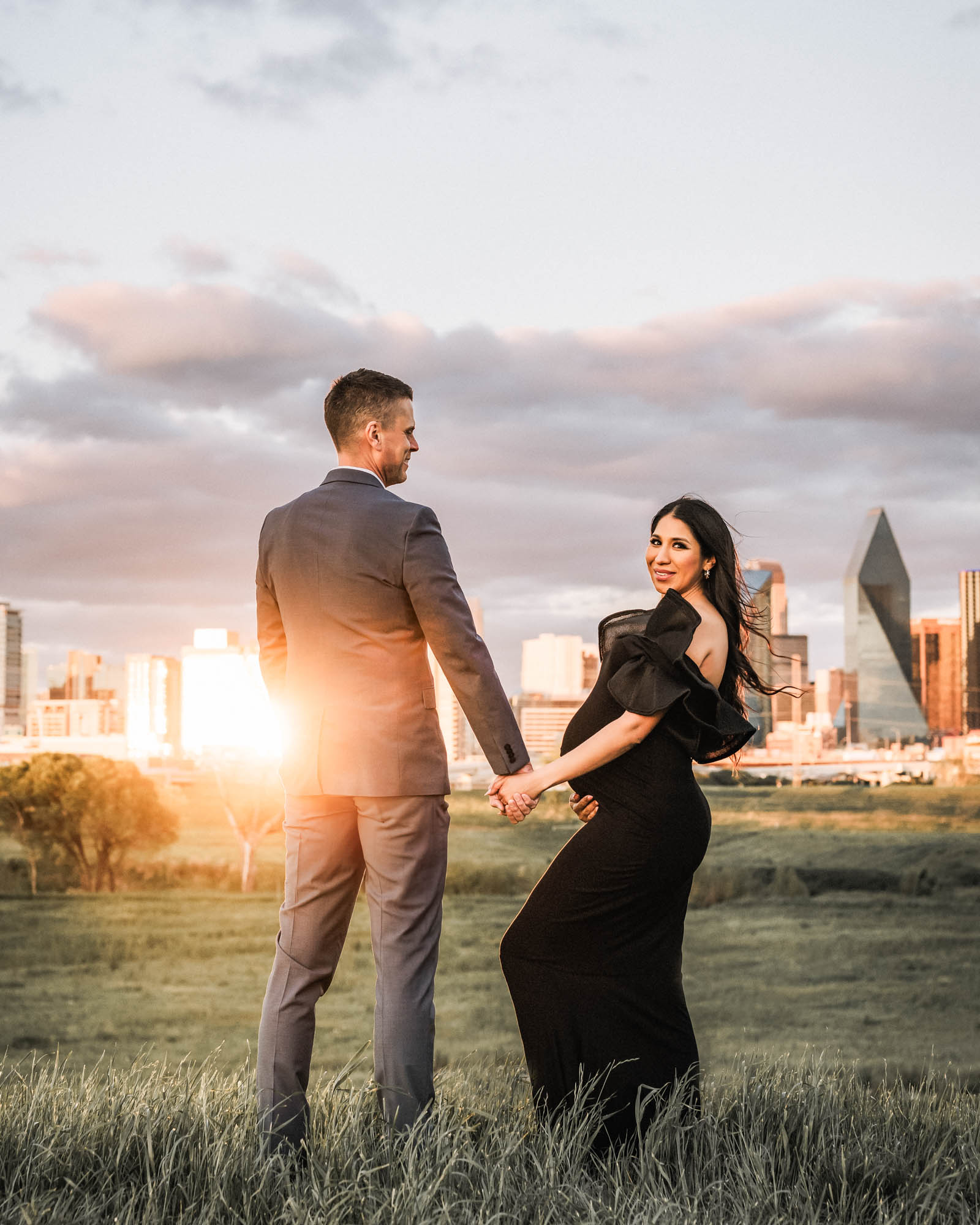 Dallas Maternity Photographer Captures Couple Holding Hands With City Skyline Backdrop