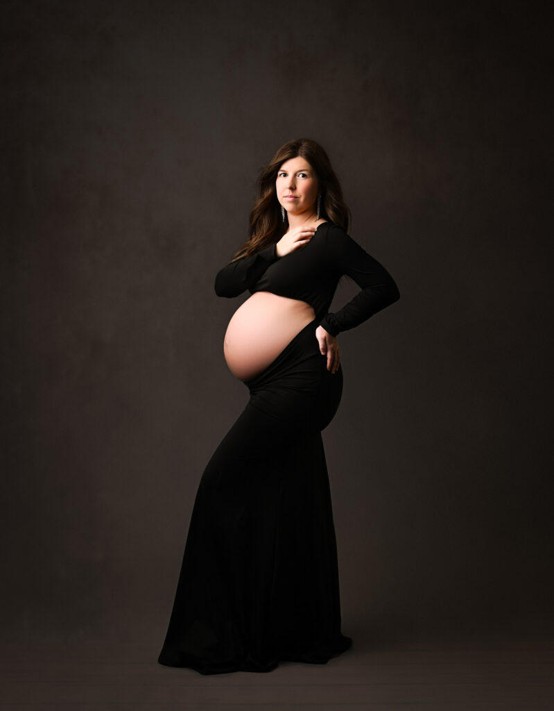 Studio Maternity Photo Of An Expecting Mother In A Glamorous Black Gown, Photographed By A Dallas Maternity Photographer