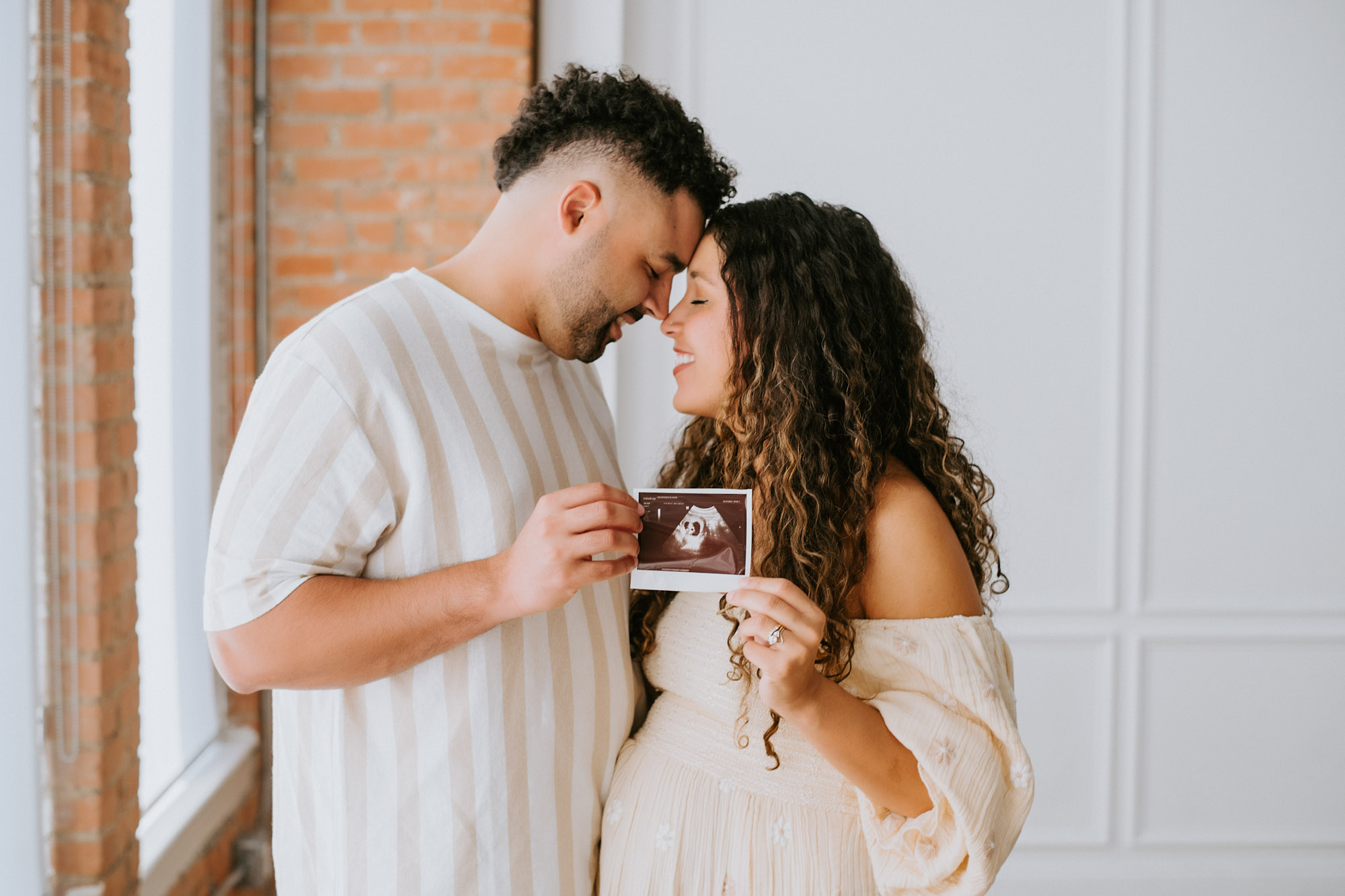Pregnant Couple Holding Ultrasound Photo During Dallas Maternity Session