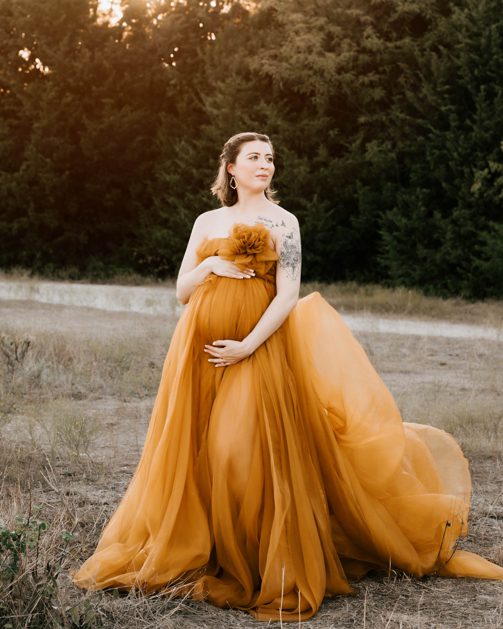 Maternity Portrait Of Mom-To-Be In Flowing Orange Gown During Dallas Photoshoot