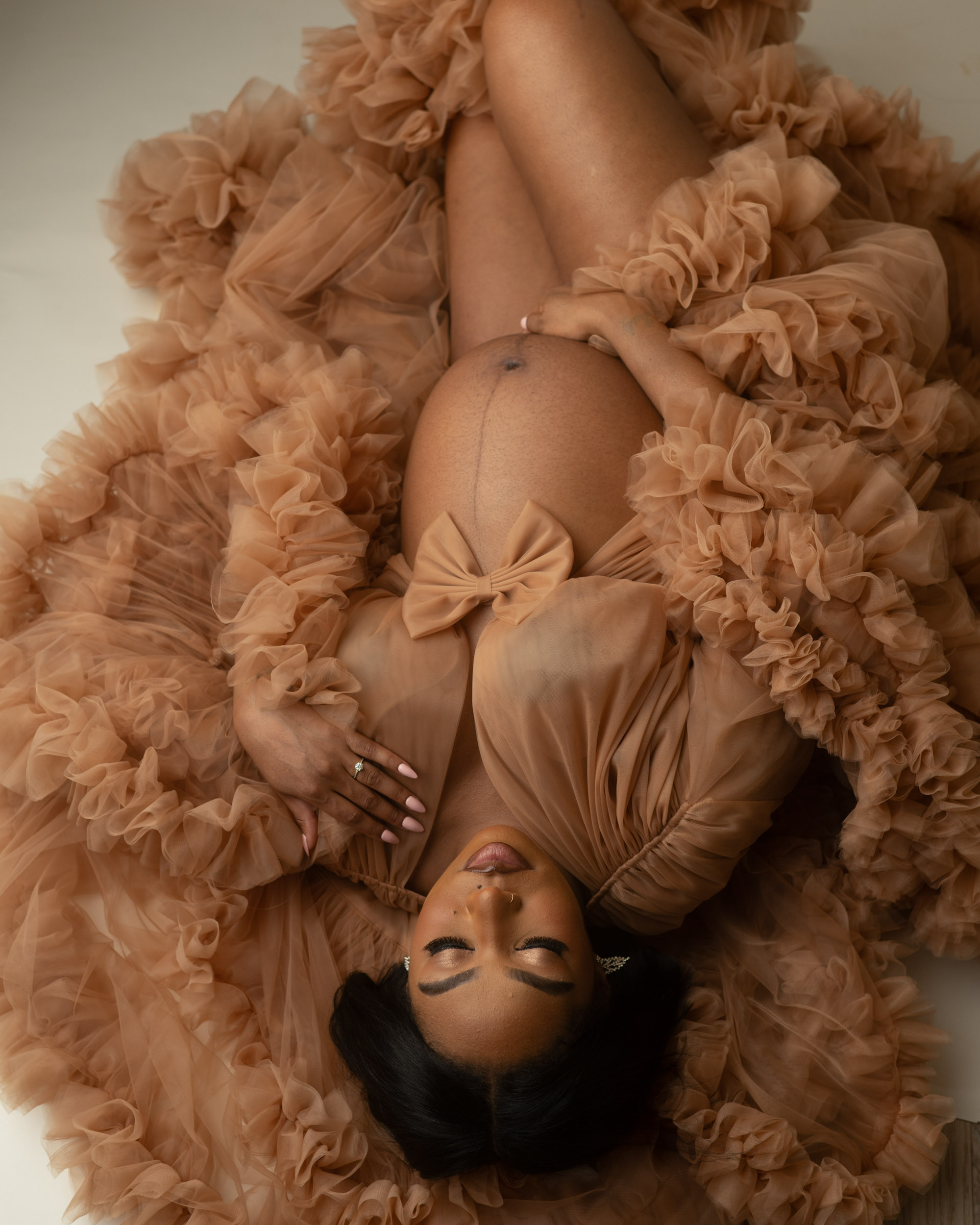 Luxury Dallas maternity photographer capturing expecting mother in ruffled gown