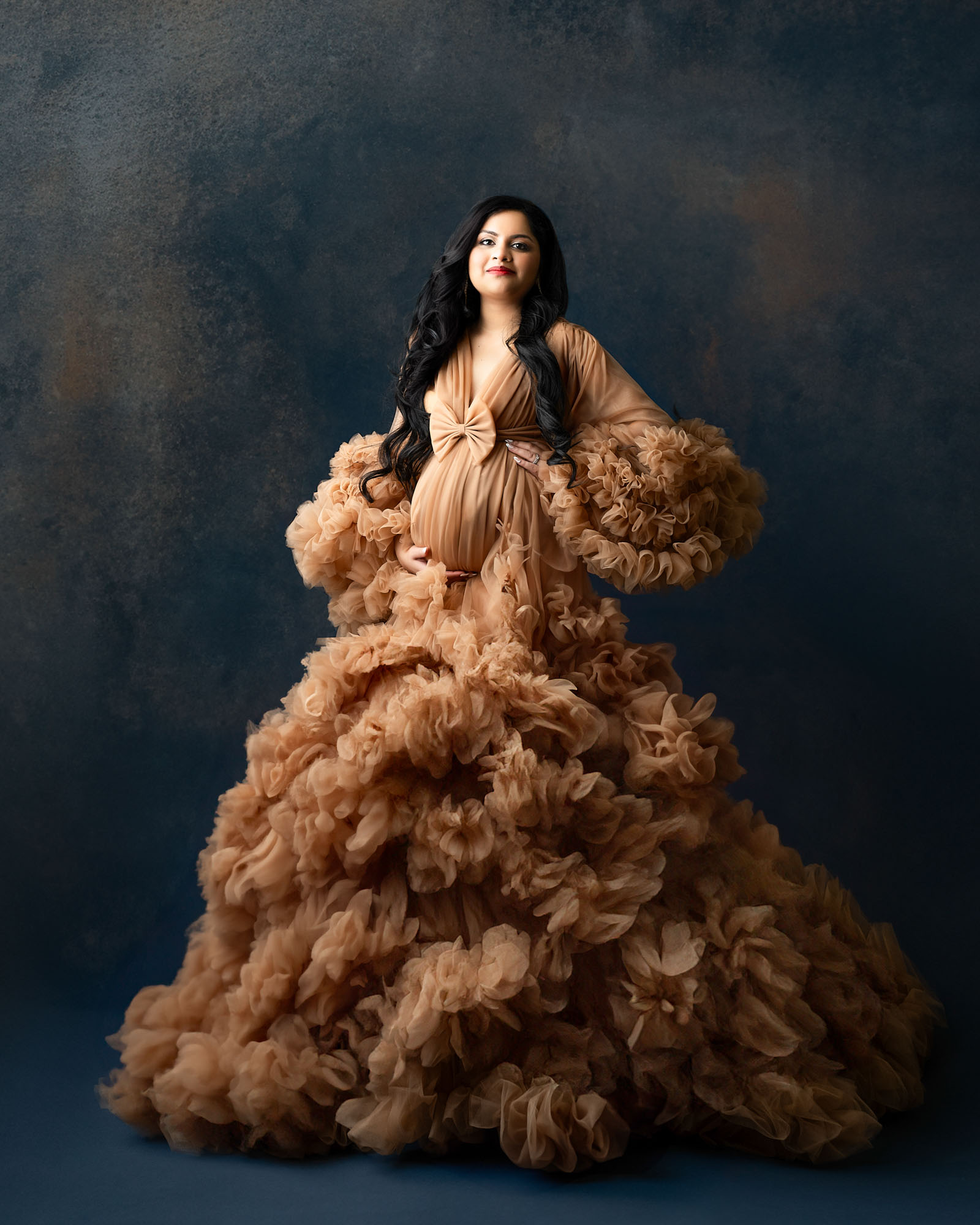 Luxury maternity portrait in Dallas studio with dramatic ruffled gown