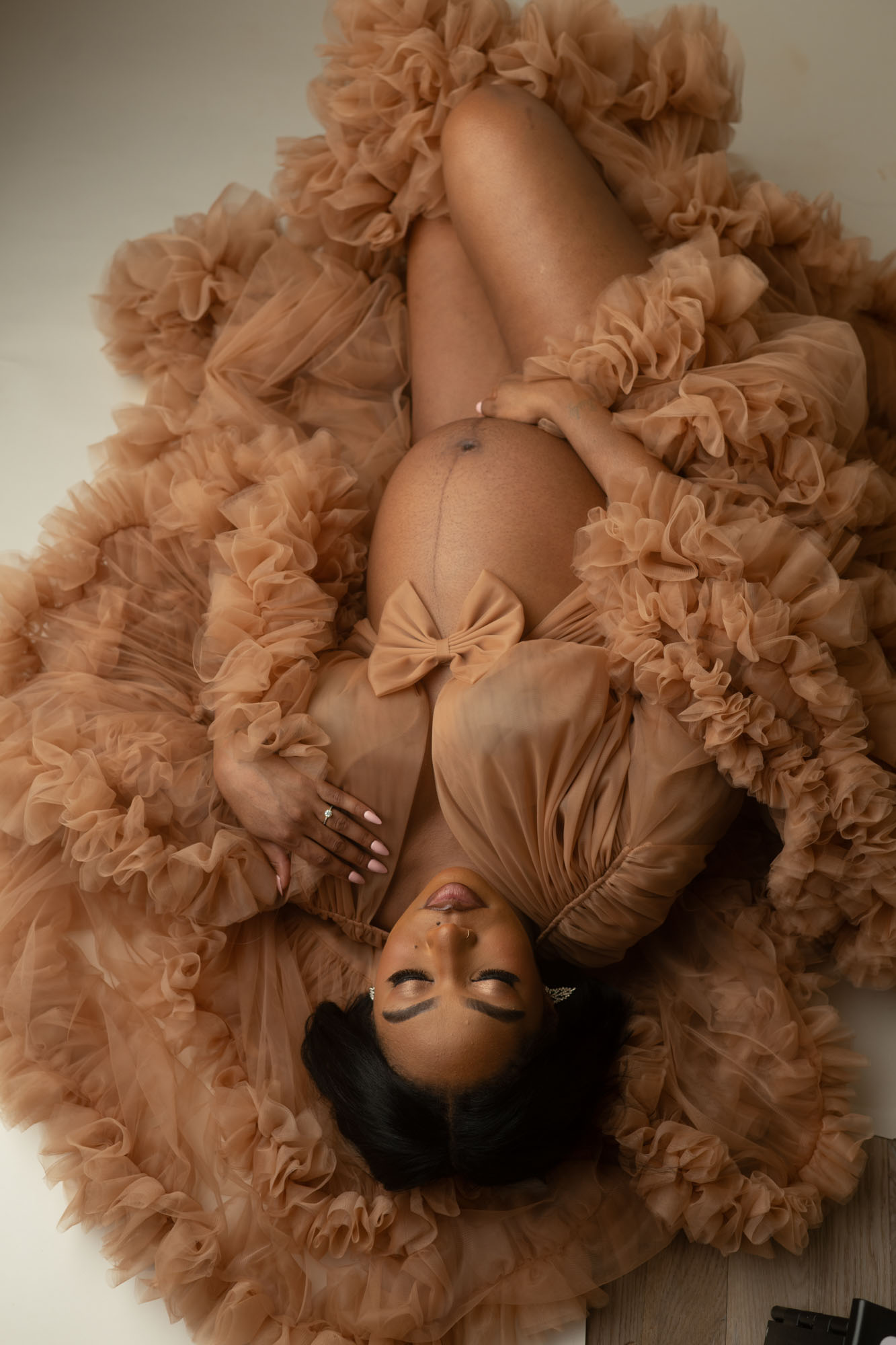 Luxury Dallas maternity photographer capturing expecting mother in ruffled gown