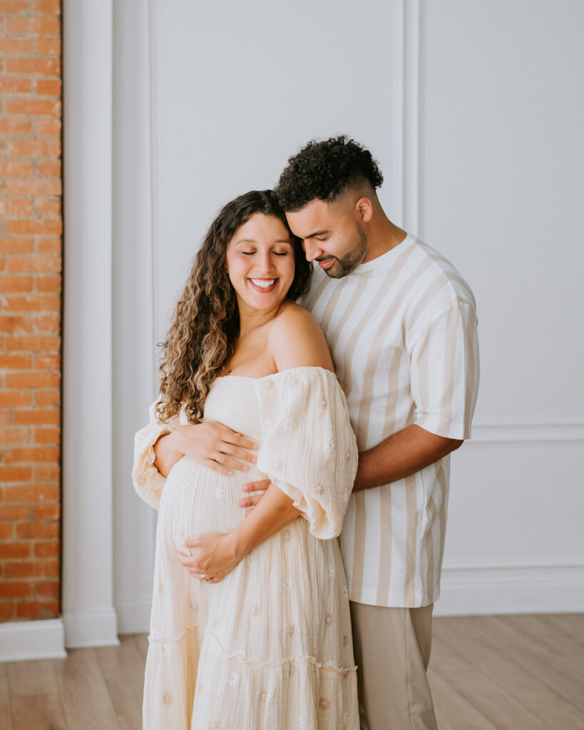 Expecting Couple Embracing During Maternity Photoshoot In Dallas Studio