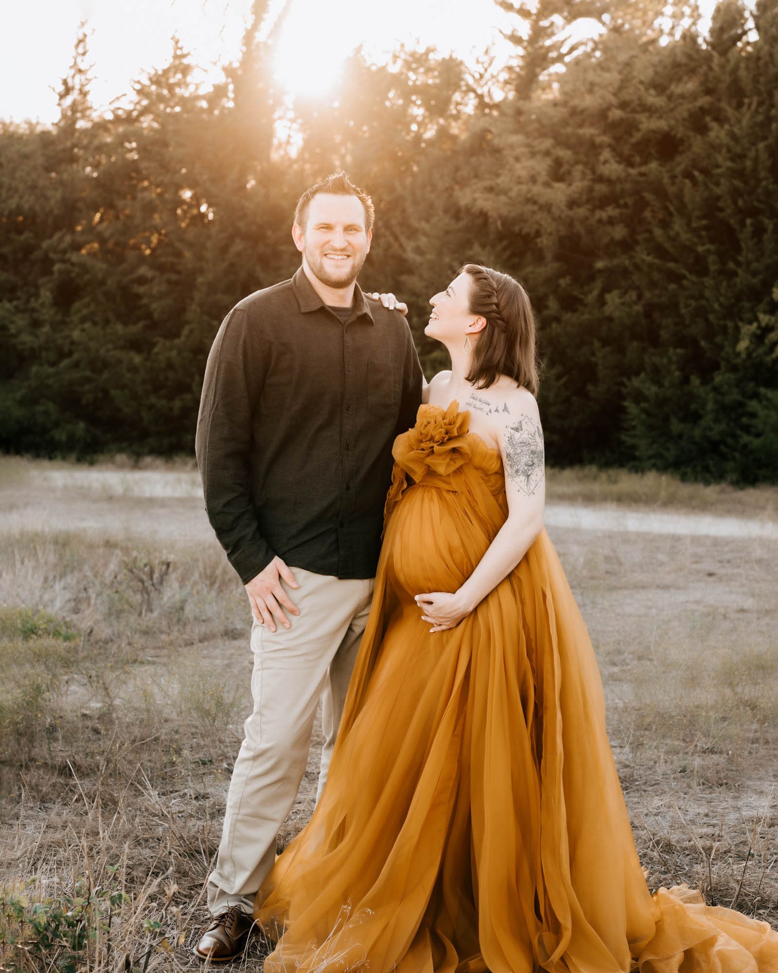 Outdoor Dallas Maternity Photography With Couple Smiling In Nature