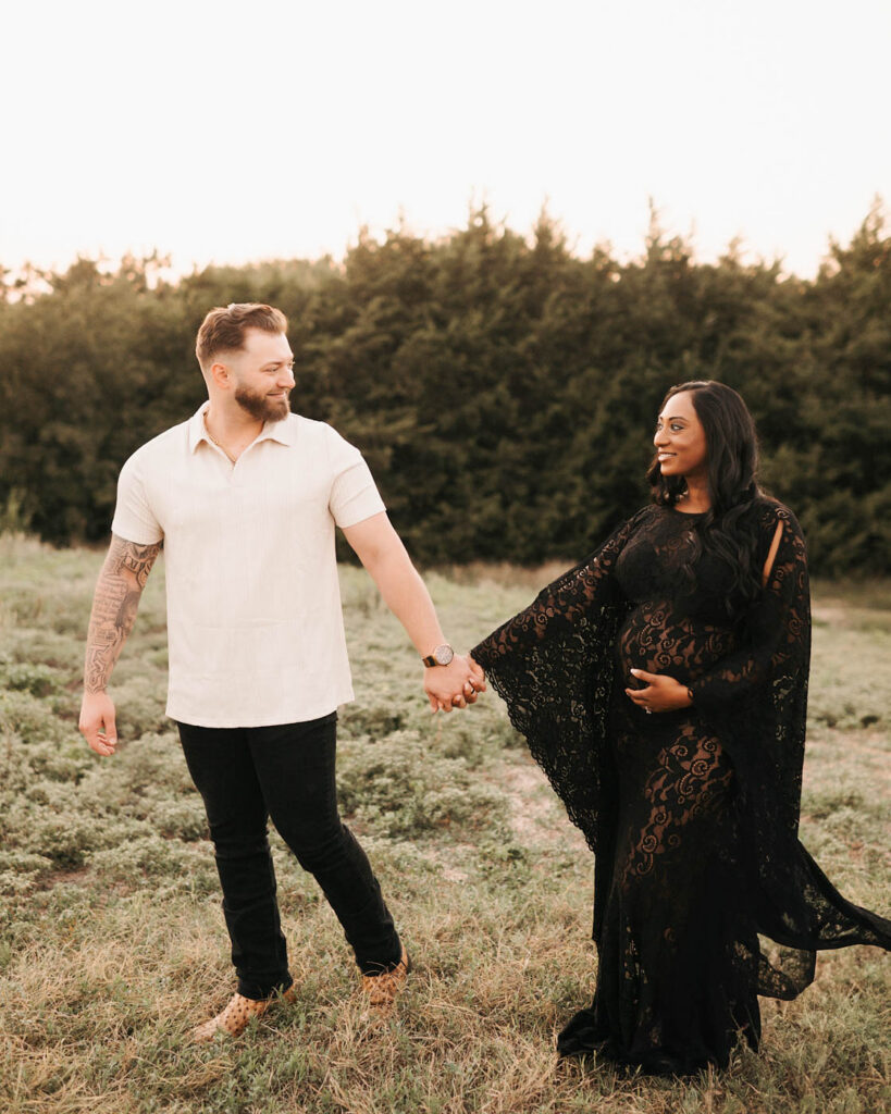 Expecting Couple Walking Hand In Hand During An Outdoor Maternity Session In Dallas