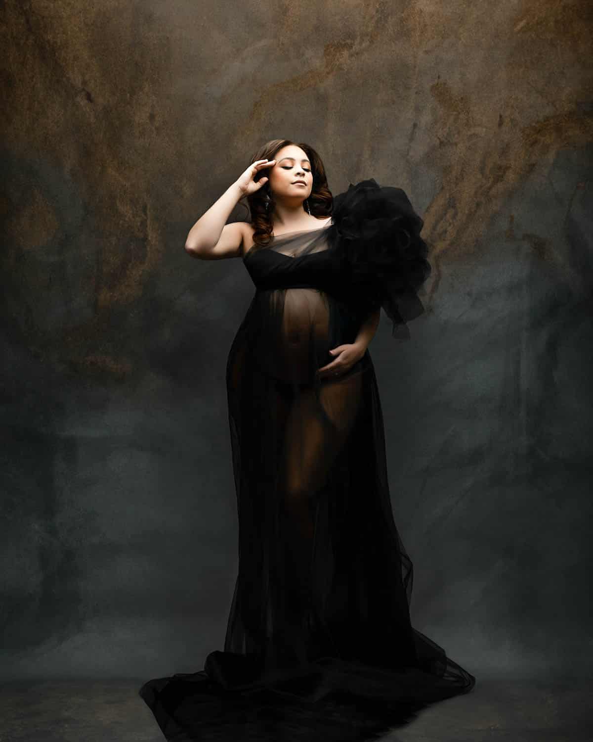Dallas maternity photographer captures mother-to-be in elegant black tulle gown during fine art photoshoot