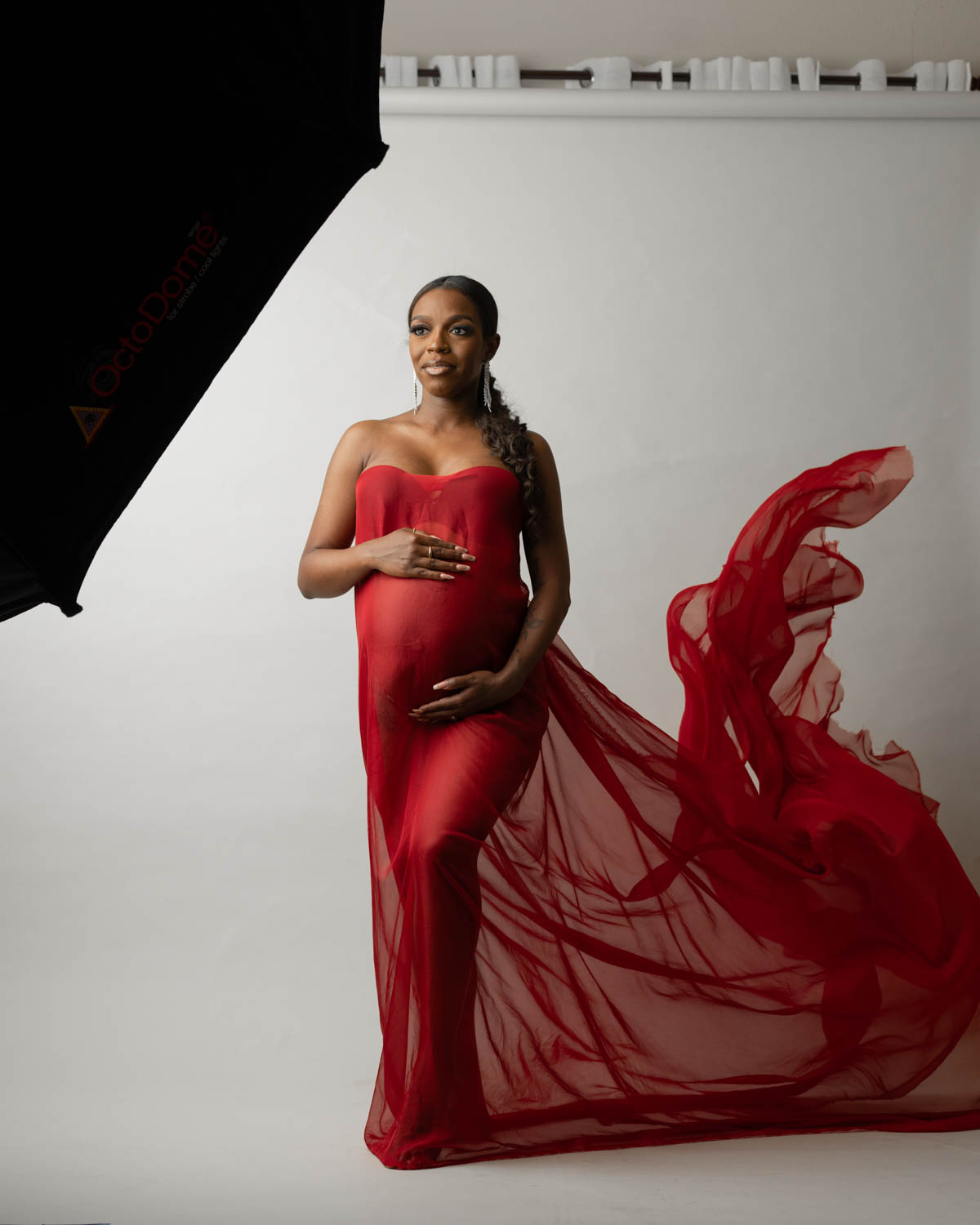 Luxury Dallas maternity photographer capturing expecting mother in ruffled gown