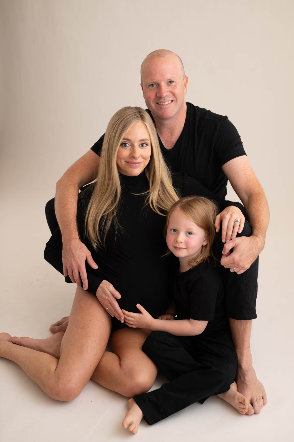 Luxury Dallas maternity photographer capturing expecting mother in ruffled gown