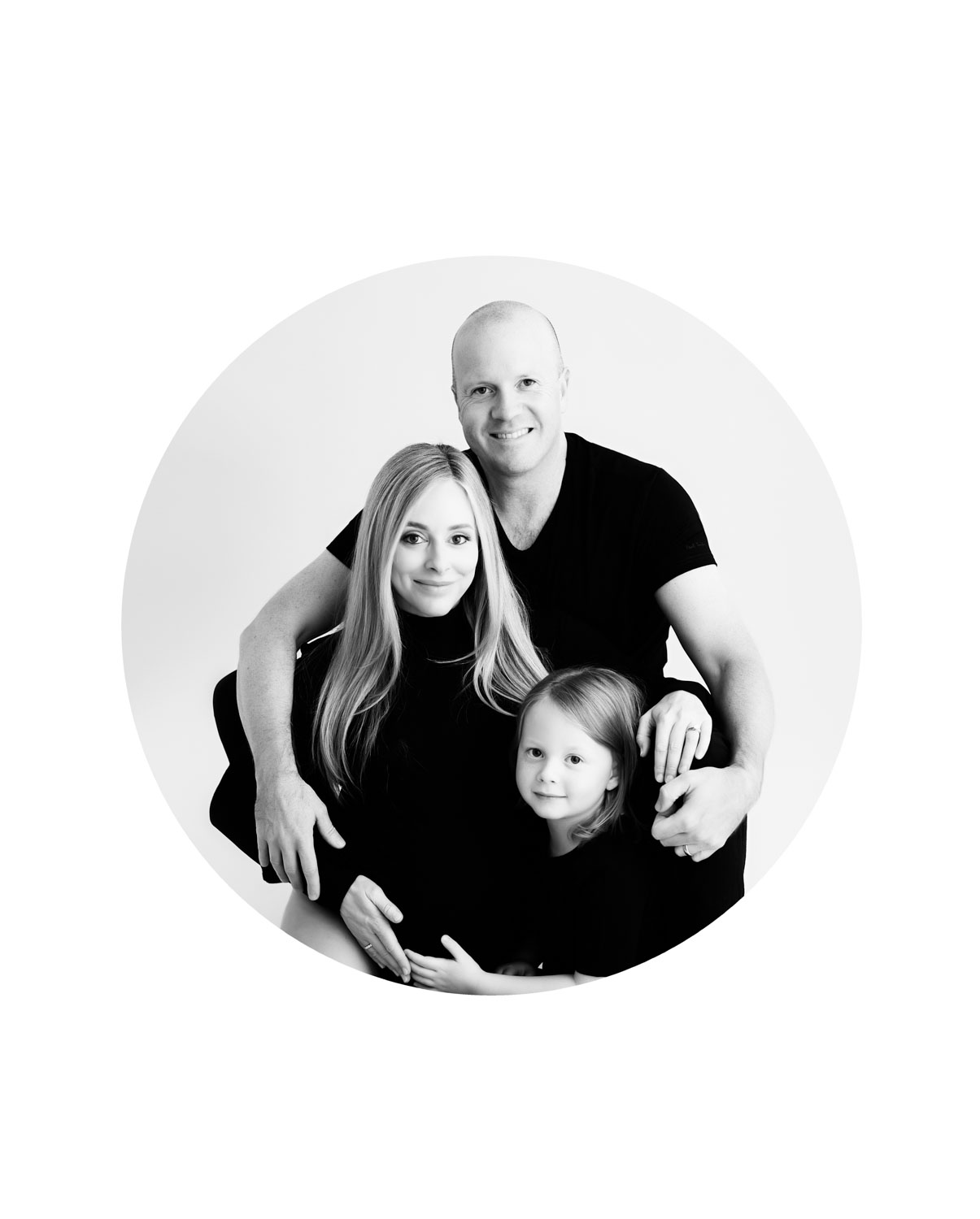 Studio maternity photography in Dallas featuring an expectant mother with her family in a clean, light-filled setting