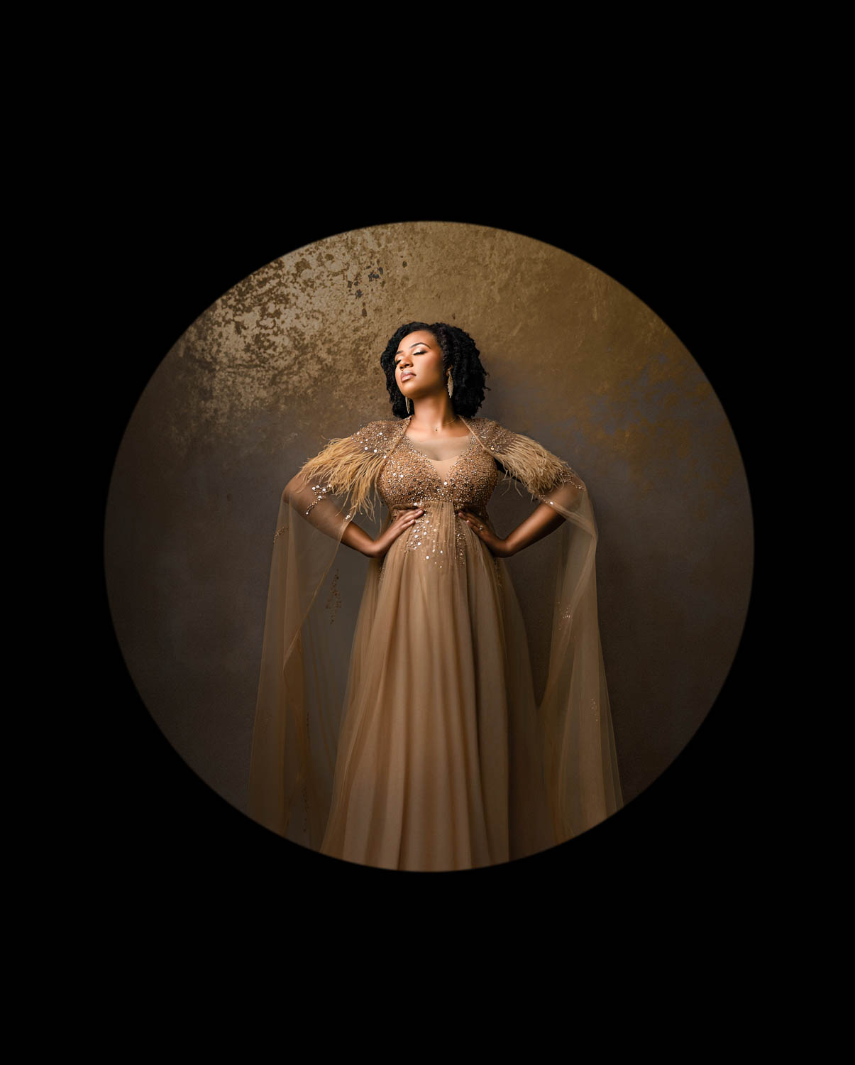 Fine art maternity photography in Dallas featuring an expectant mother in dramatic studio lighting