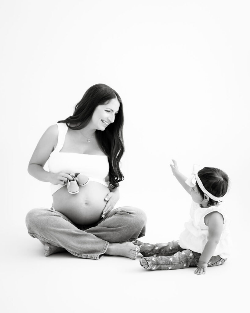 Studio Maternity Photography With Toddler | Dallas Maternity Photographer 9 Toddler Interacting With Mother During Dallas Studio Maternity Session