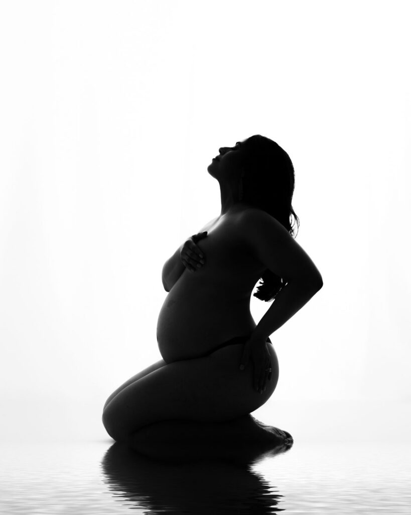 What Happens After Your Maternity Session? From Proofing To Delivery 16 Silhouette Maternity Photoshoot In Dallas Featuring An Expectant Mother Posed In An Artistic Fine Art Pregnancy Portrait.