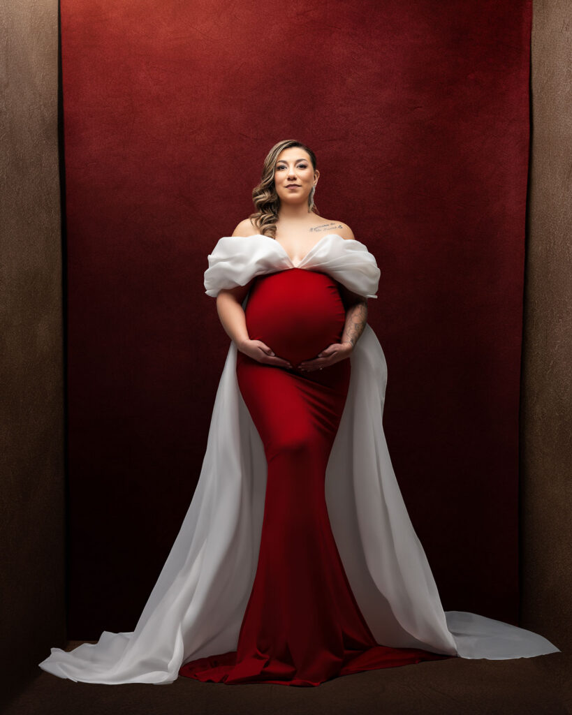 How Luxury Maternity Photography Creates Timeless Artwork 6 Dallas Maternity Photographer Captures Pregnant Mother Posing In A Red Gown During A Luxury Editorial Maternity Photography Session In Dallas Studio
