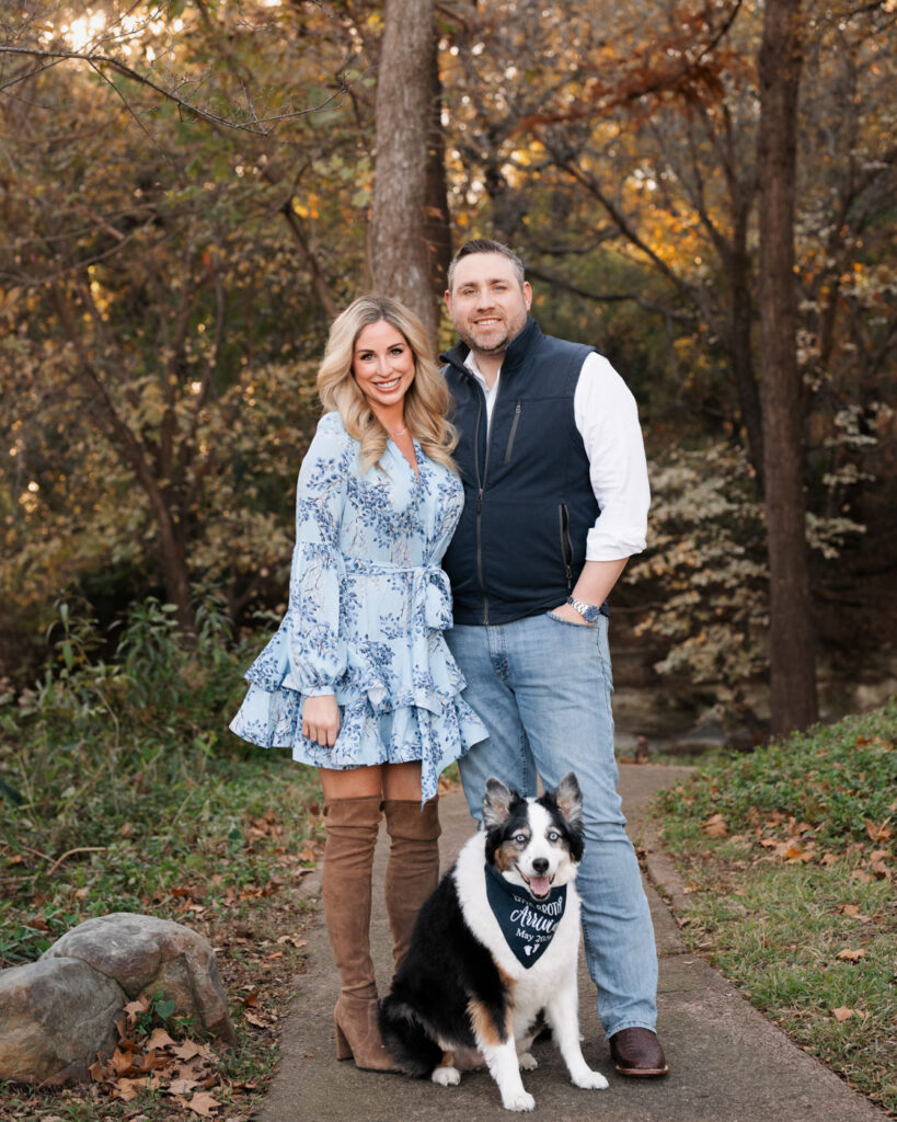 A Sweet Fall Baby Announcement Session In Dallas 8 Expecting Couple Posing With Their Dog During An Outdoor Maternity Photography Session In Dallas Texas.