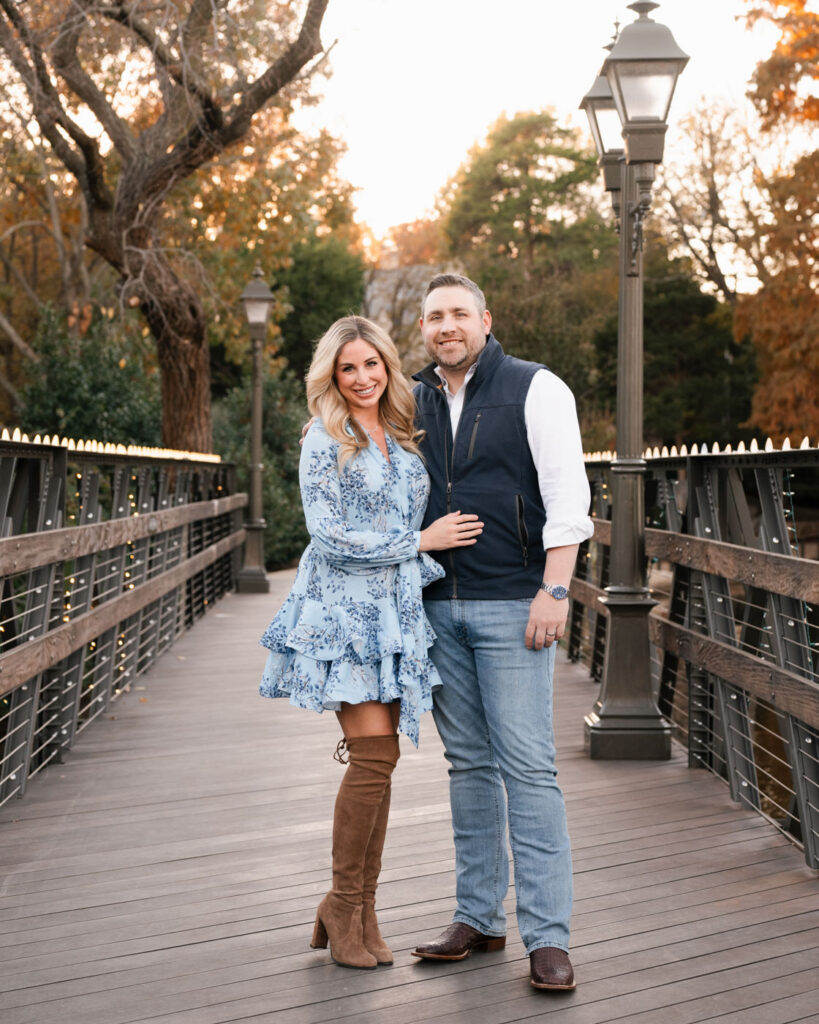 Expecting Couple Standing Together On A Bridge During An Outdoor Maternity Photography Session In Dallas.
