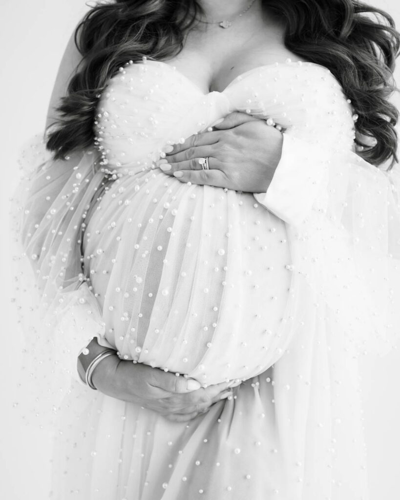 What Happens After Your Maternity Session? From Proofing To Delivery 13 Close-Up Fine Art Maternity Portrait Of An Expectant Mother And Partner Embracing Her Baby Bump During A Dallas Studio Maternity Session.