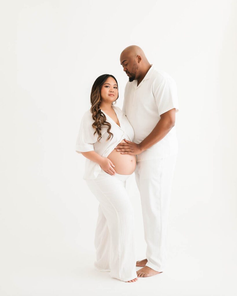 Maternity Photographer Dallas Full-Length Portrait Of An Expecting Couple Dressed In White