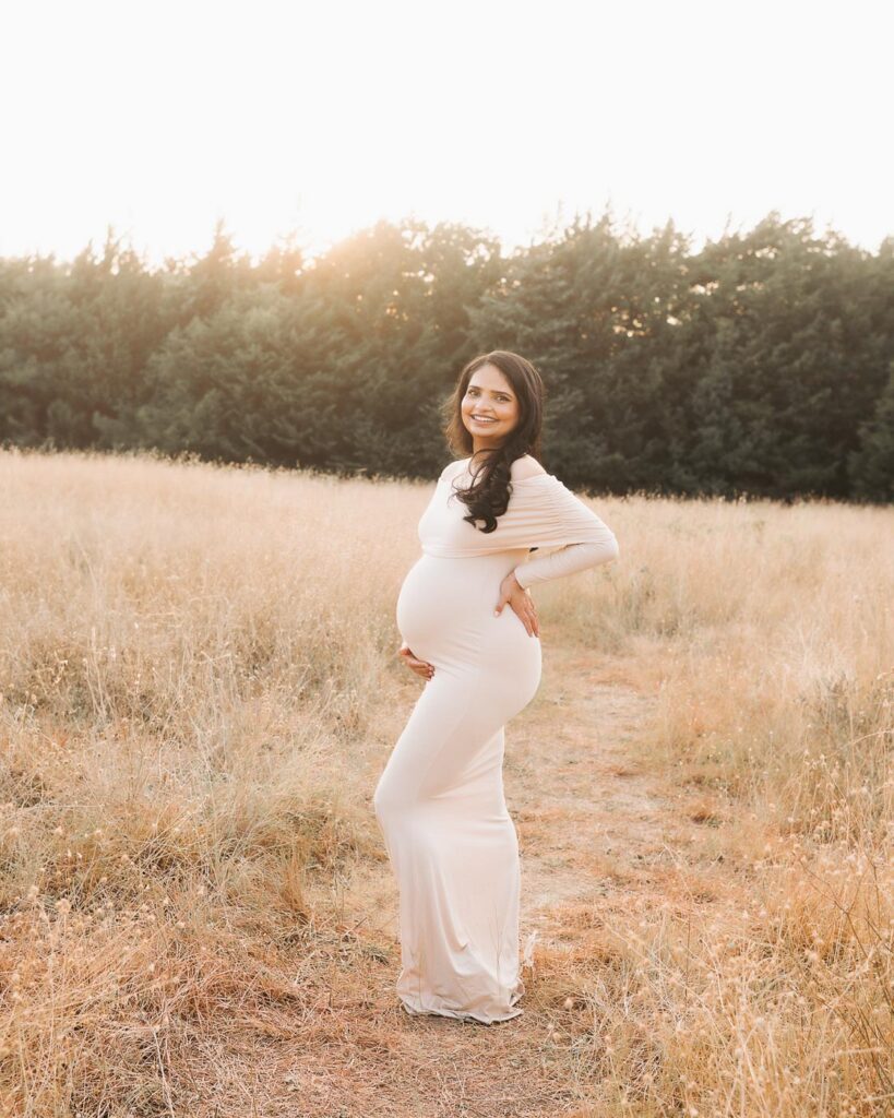 Expecting Mother Posed In Profile During Outdoor Maternity Photos In Dallas On A Warm Summer Evening.
