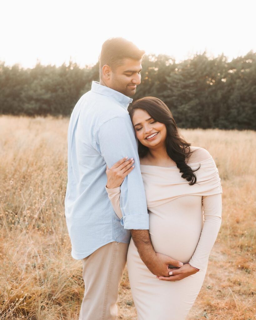 Expecting Mother Leans Toward Her Partner During A Relaxed Summer Maternity Photoshoot In Dallas.