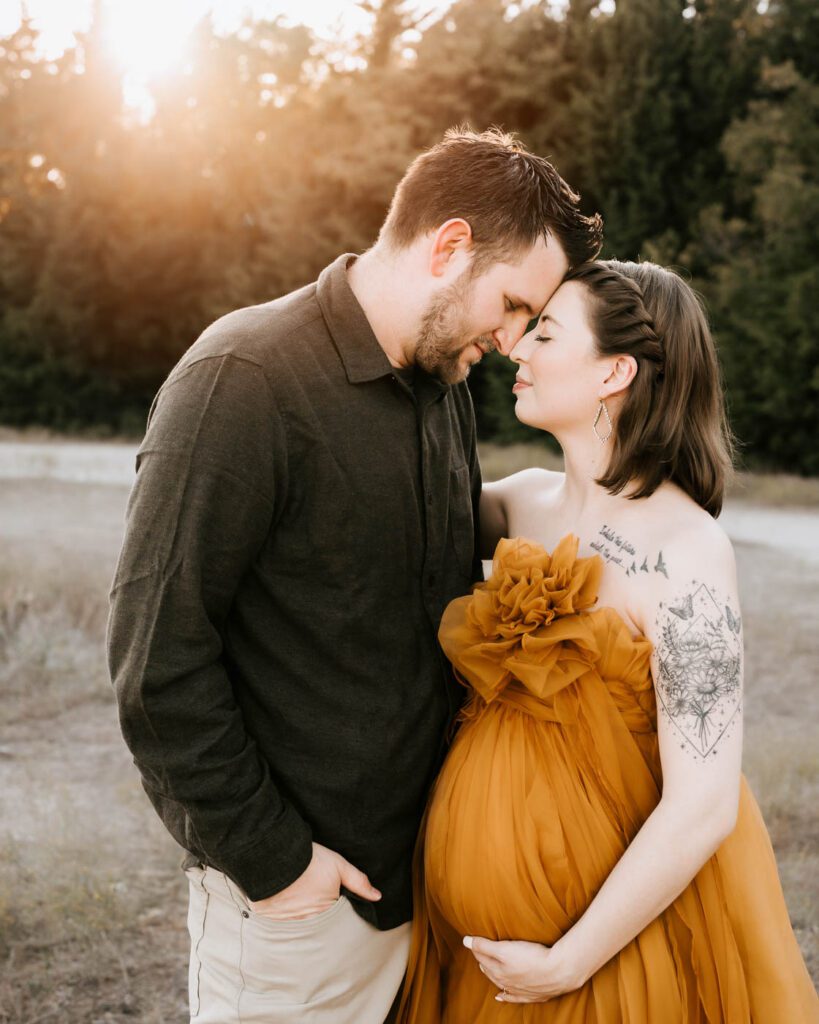 Dallas Maternity Photography With Expecting Mother In A Mustard Gown Posing Closely With Her Partner