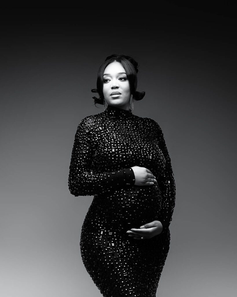 Dallas Maternity Photography Featuring A Black And White Studio Portrait In A Fitted Sequined Maternity Gown